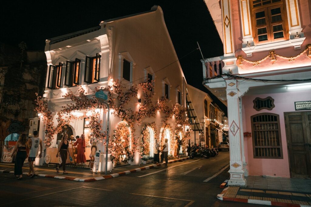 People standing outside of a building on the streets of Phuket's Old Town - Thai Pass