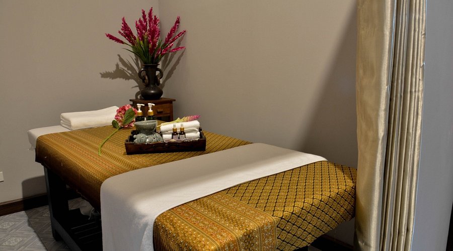 A spa bed with essential oils in a massage parlour - Thai Pass