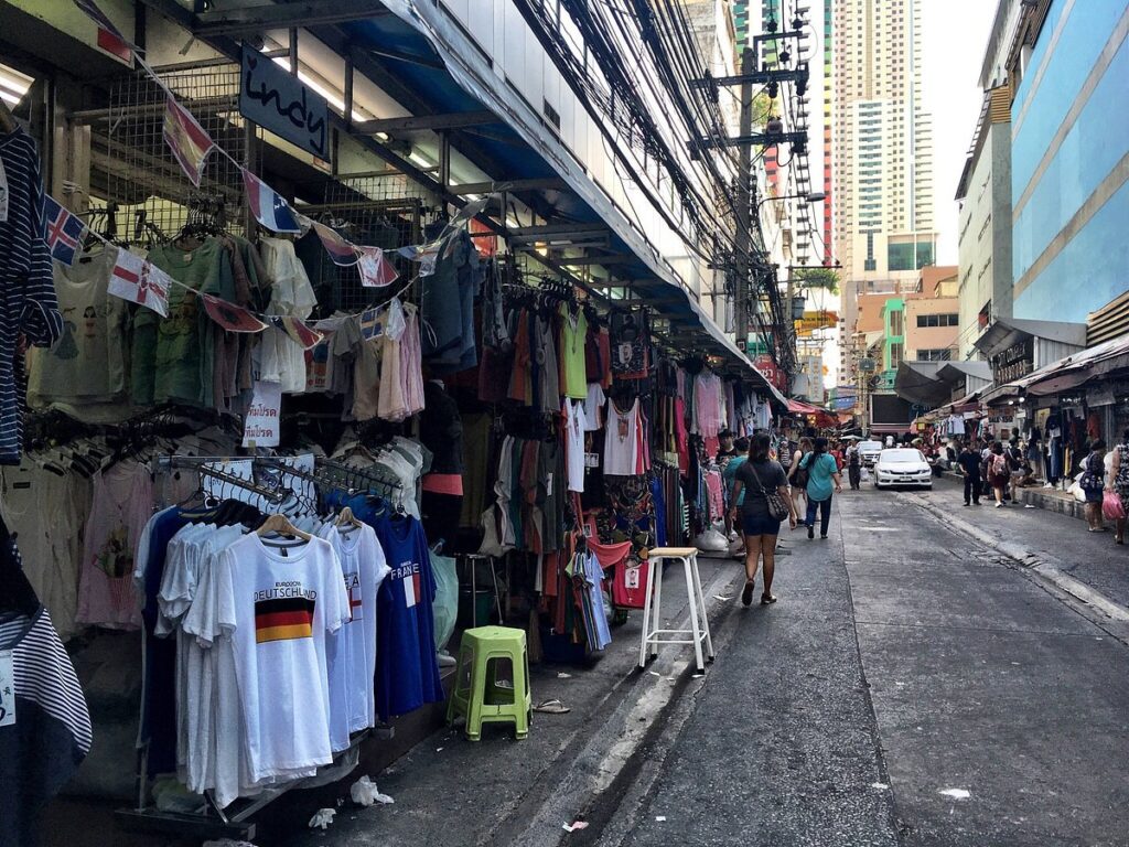 People shopping for various clothing items in Pratunam Market - Thai Pass